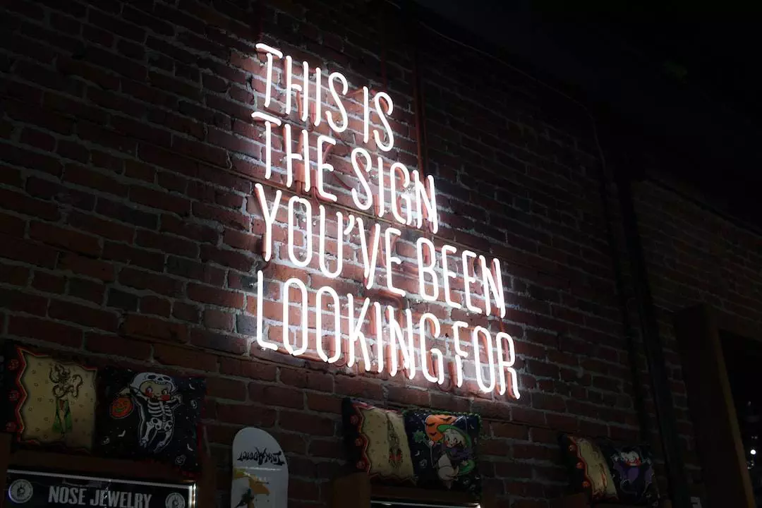 Neon sign on brick wall: 