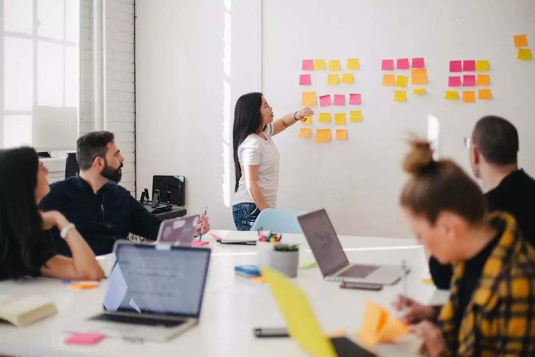 Team brainstorming with sticky notes in office.