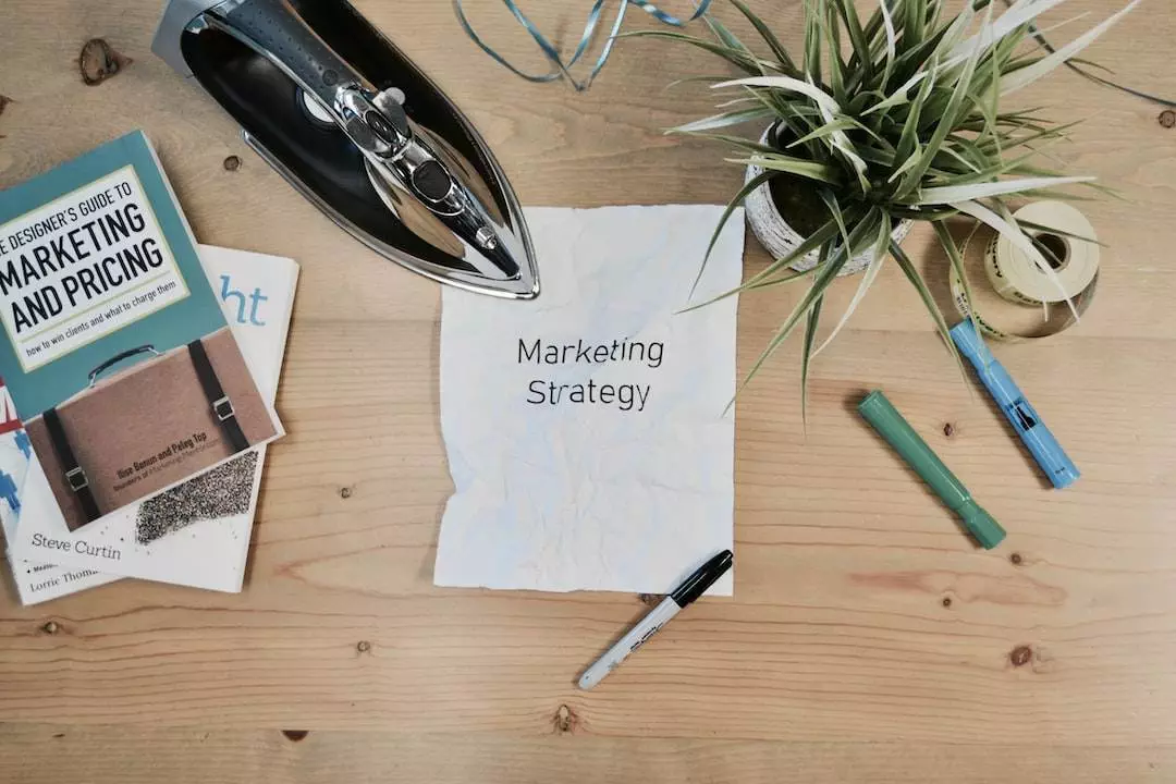 Marketing strategy planning on wooden desk with books.