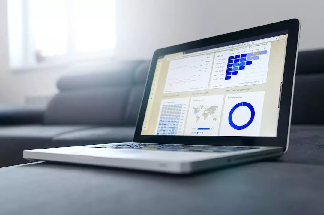 Laptop displaying analytics graphs and data charts.