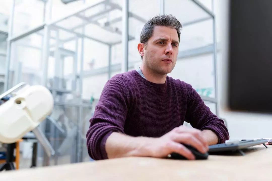 Man working focused at office desk.