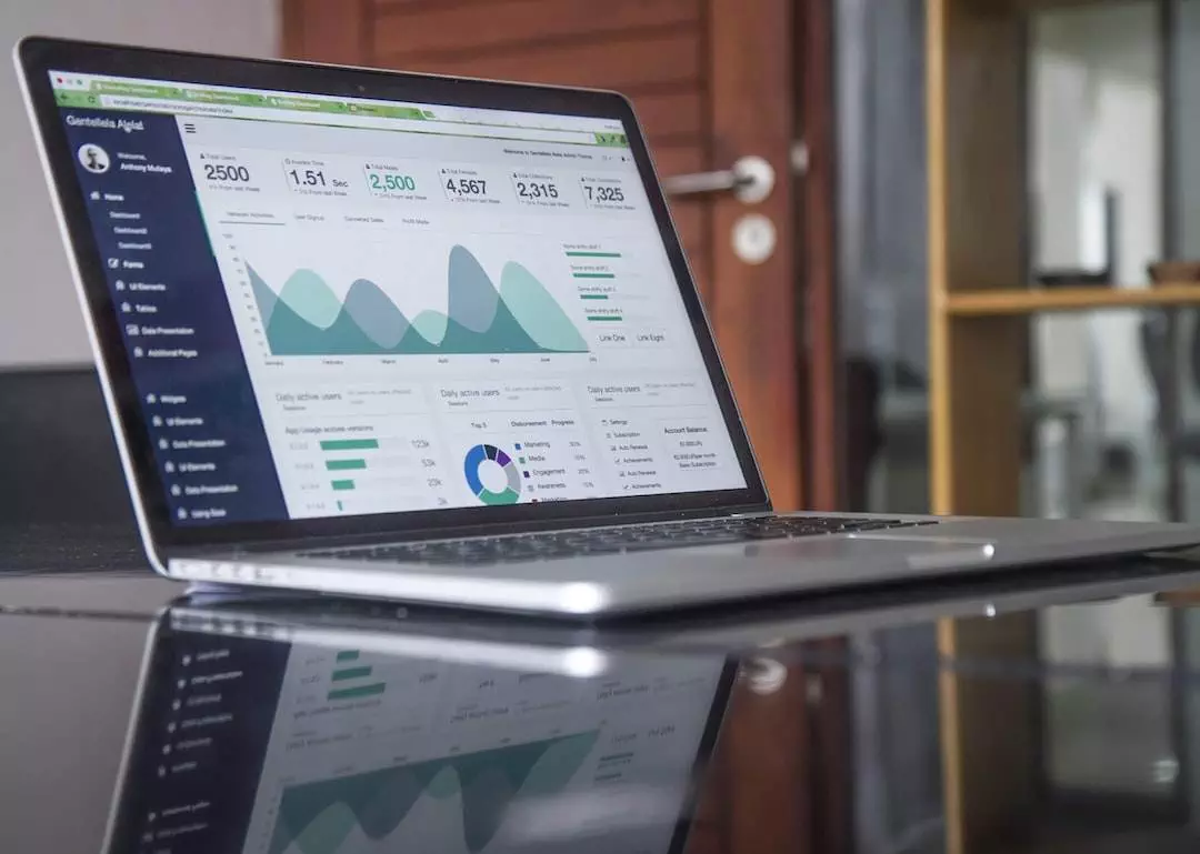 Laptop displaying analytics dashboard on screen.