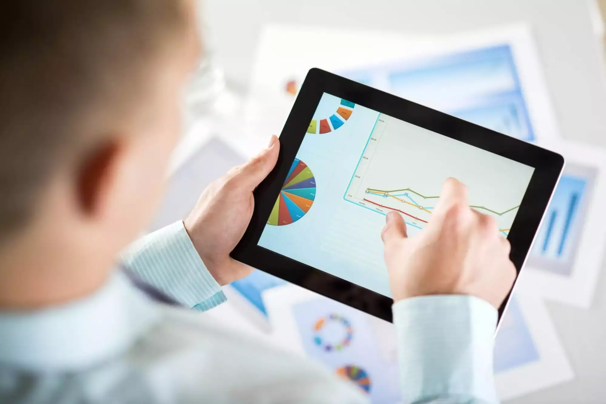 Man checking affiliate marketing stats on his tablet