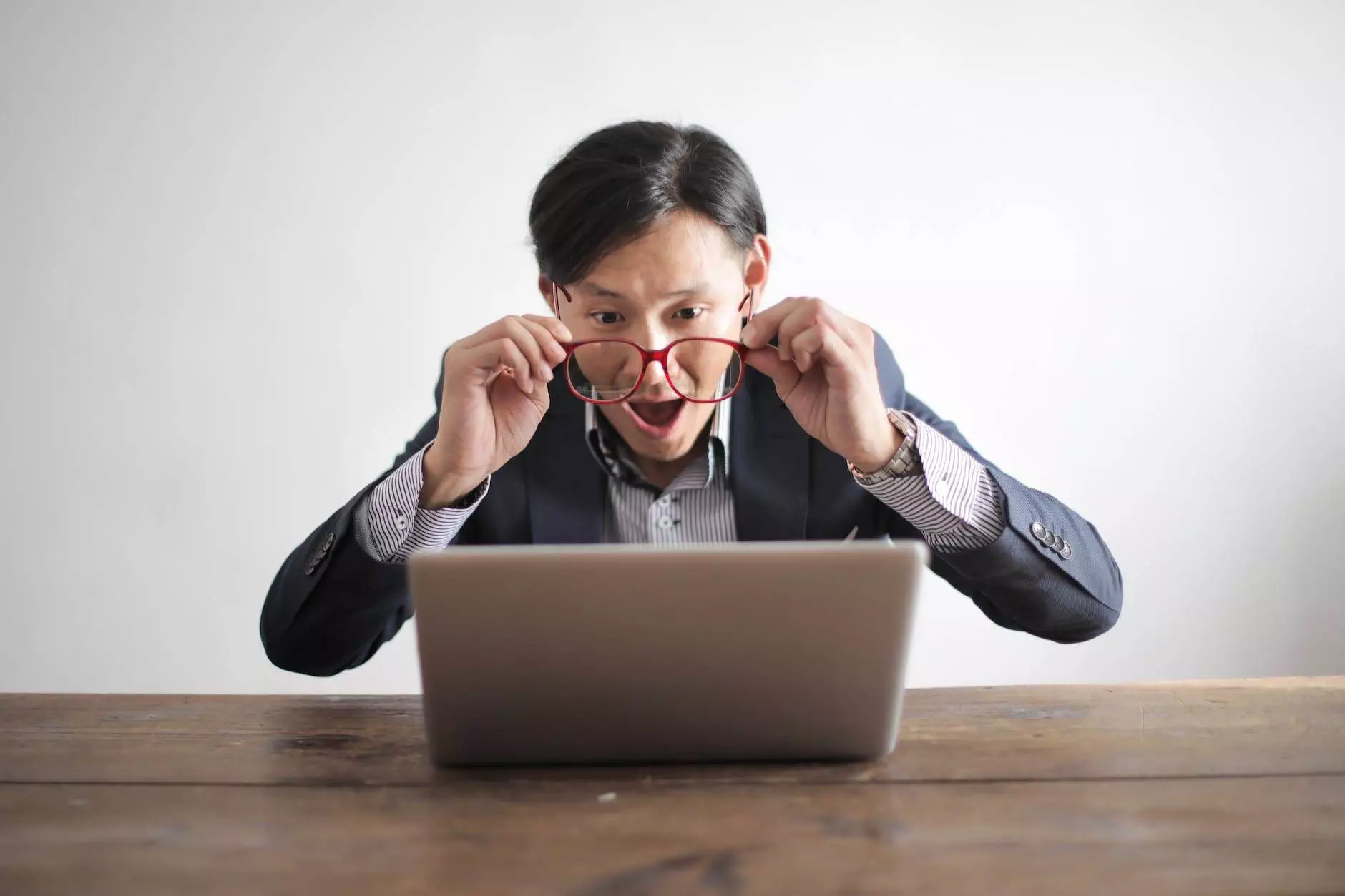 amazed formal male looking at laptop screen