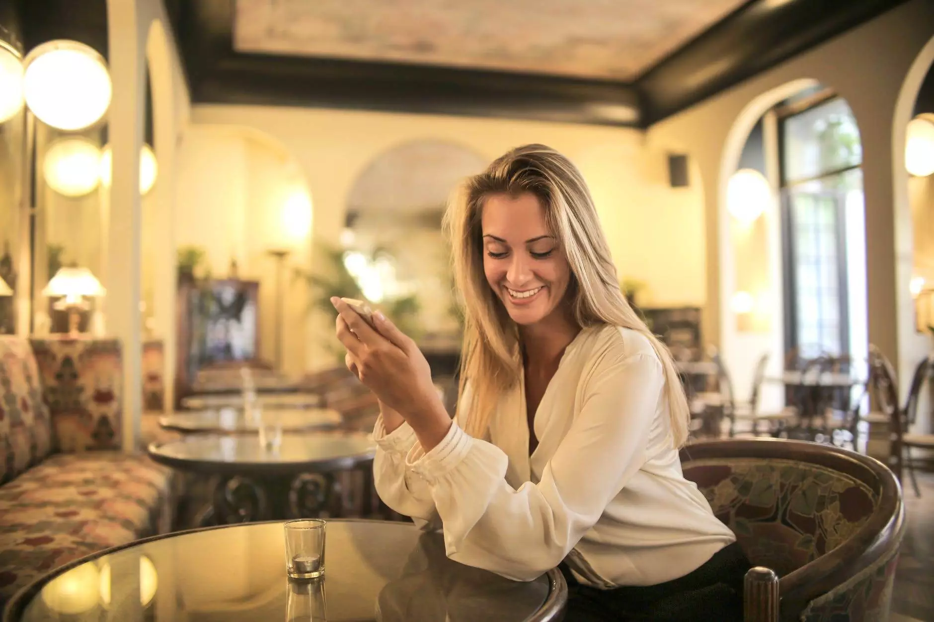 cheerful female having drink in elegant bar