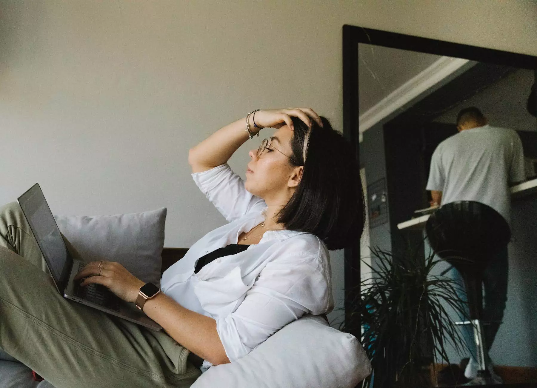 focused woman using laptop on cozy sofa