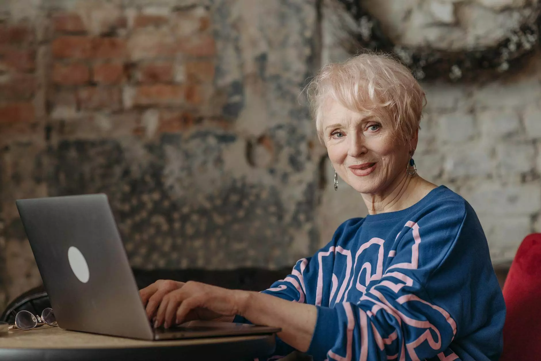 elderly woman working on laptop