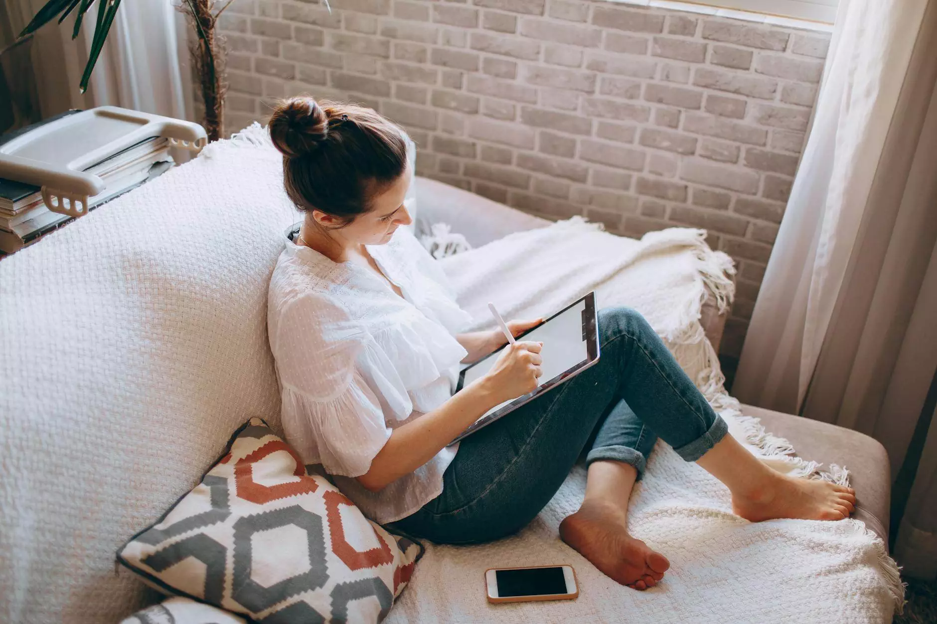 young woman using tablet on couch