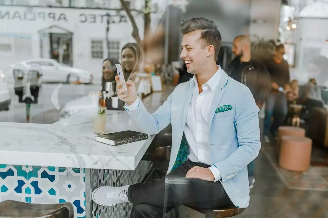 Man taking selfie at a trendy cafe.