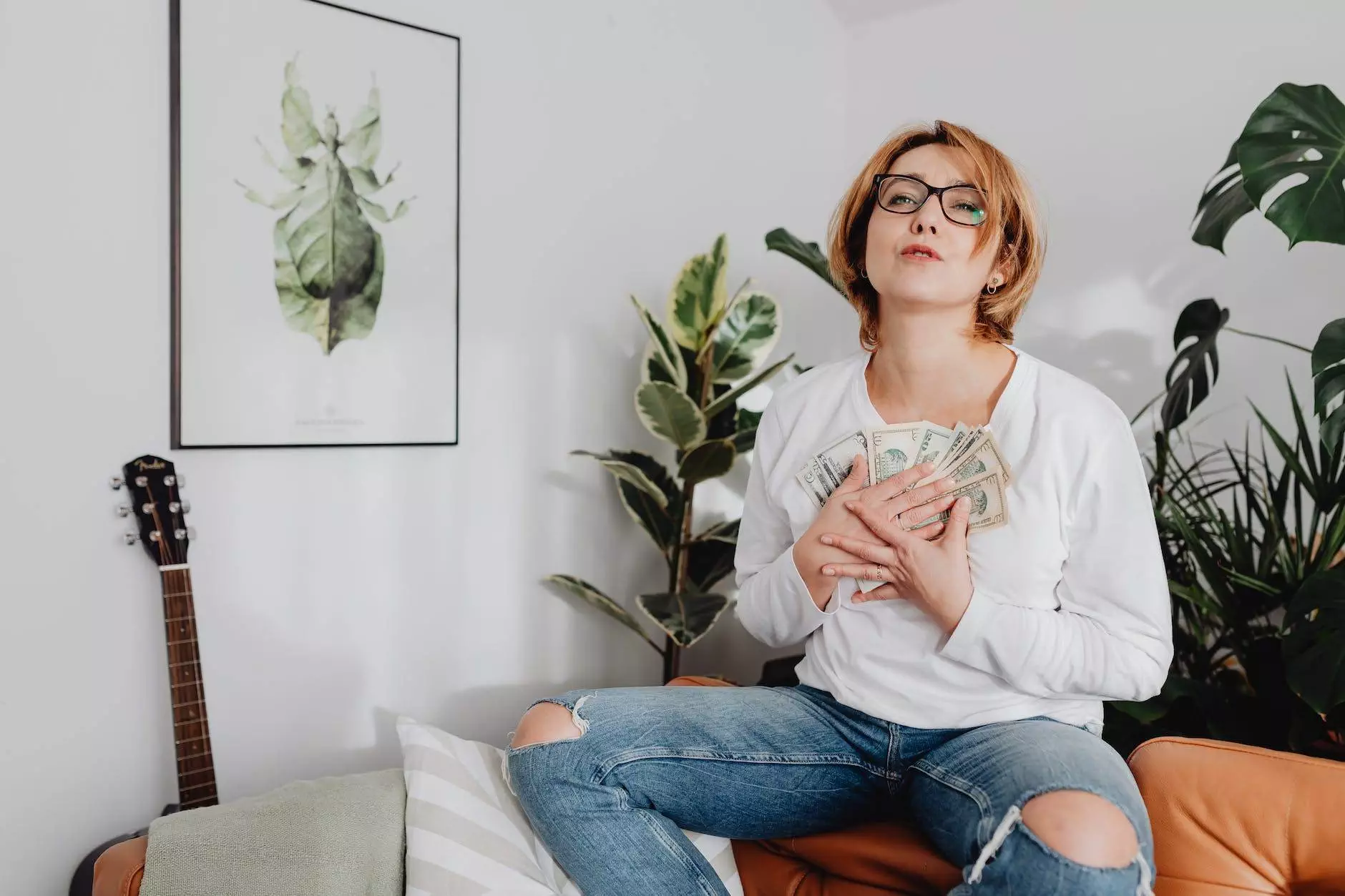 woman sitting on a couch and hugging a bunch of money