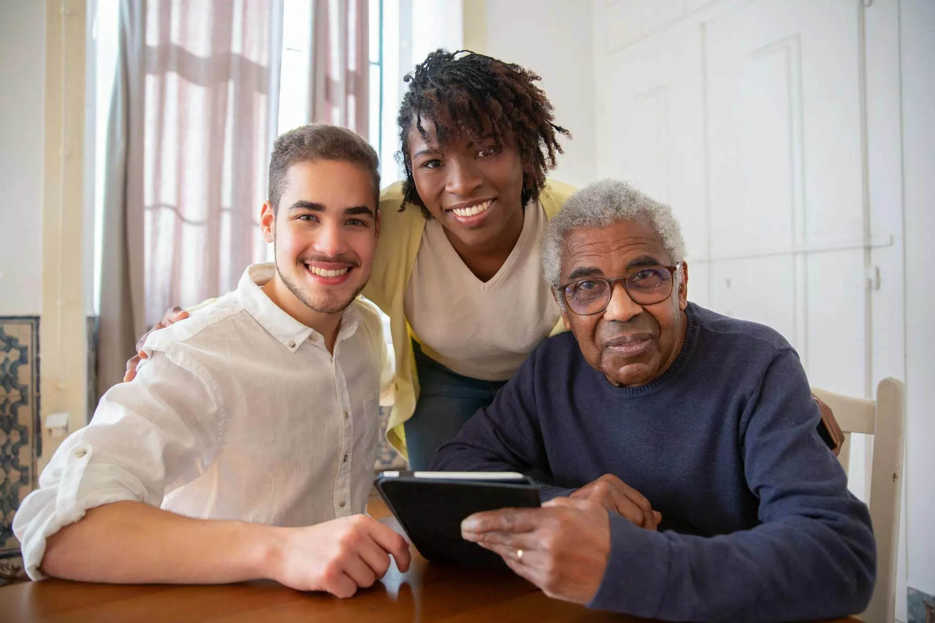 a group of people smiling together while sitting near the table