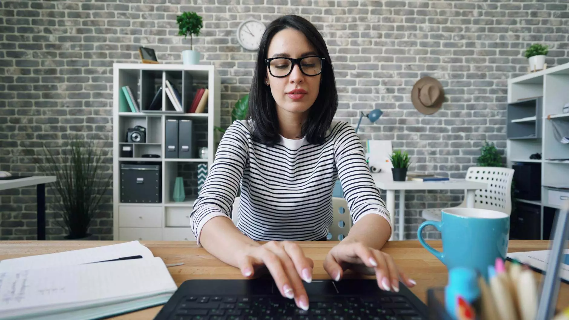 woman sitting and typing on laptop