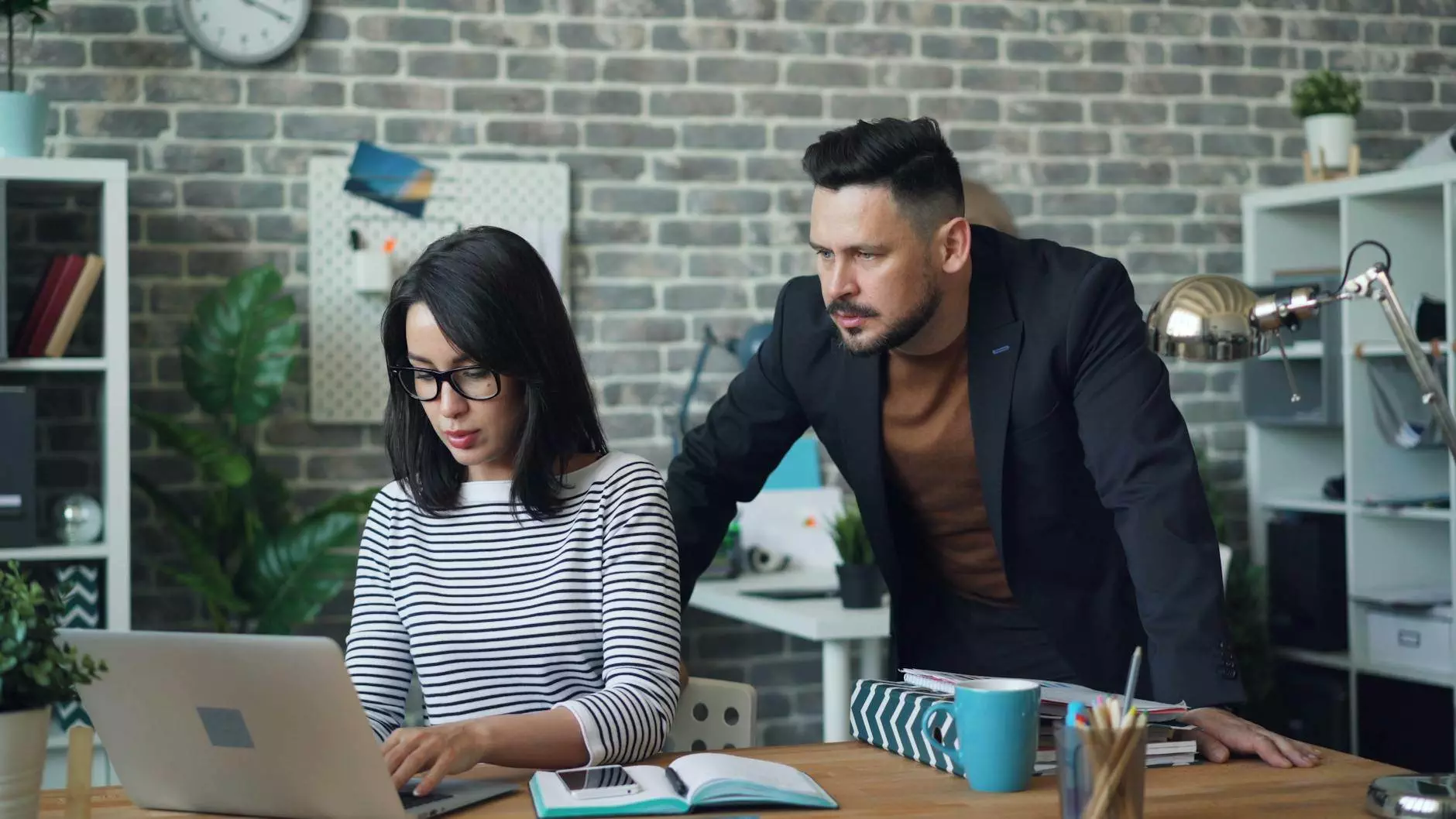 office workers working together using a laptop