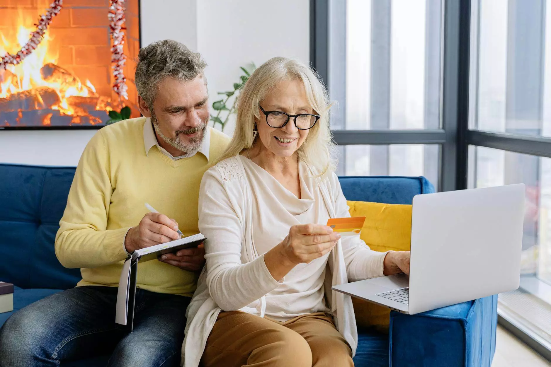 an elderly couple looking at a bank card