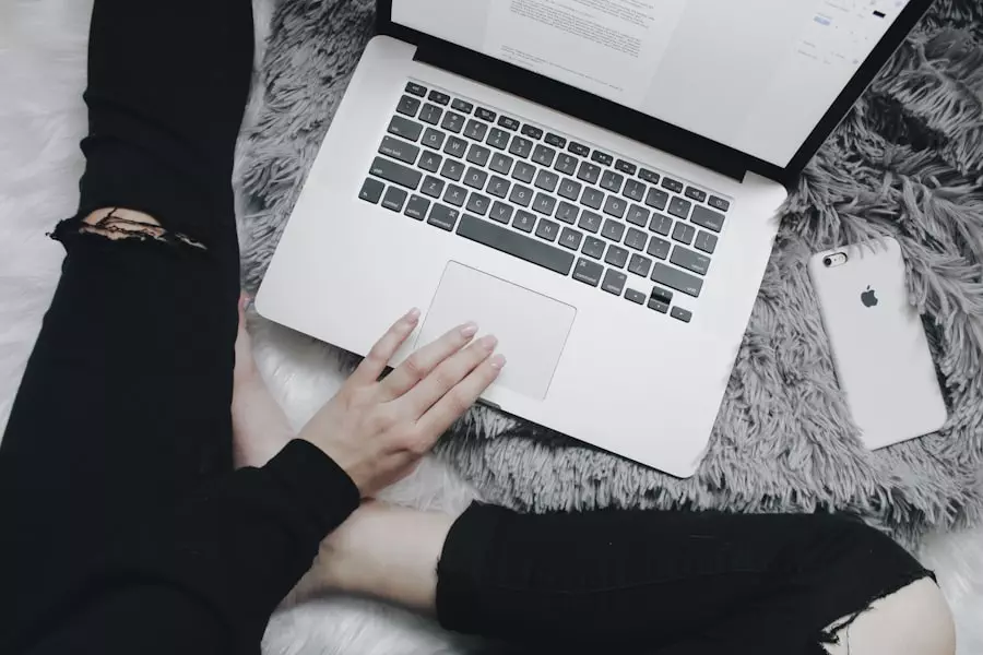 Woman working on laptop sitting on the floor