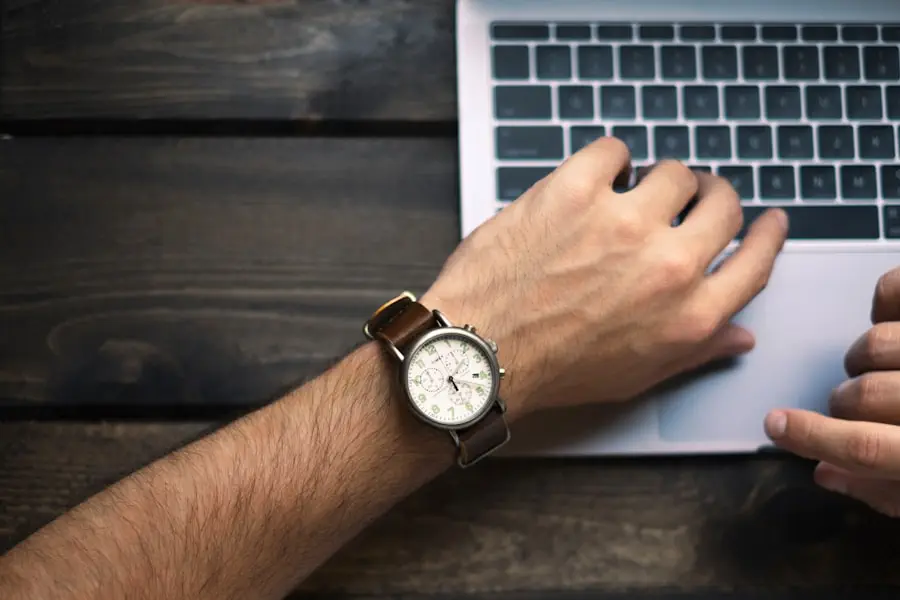 mans hands typing on laptop